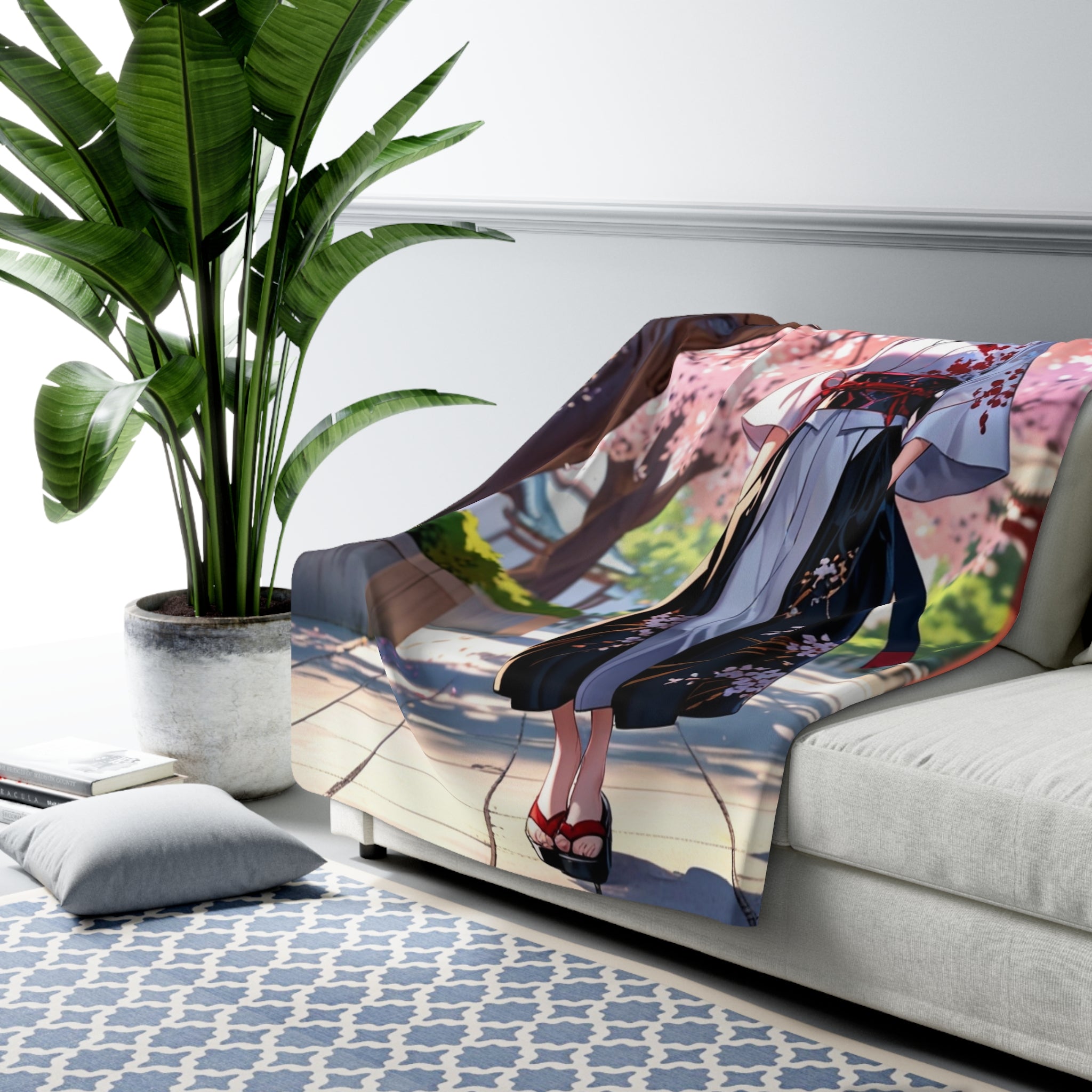 Sofa with a colorful blanket featuring a character design, next to a potted plant and a rug.
