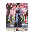 Fleece blanket with anime-style design of a woman in a kimono under cherry blossoms.